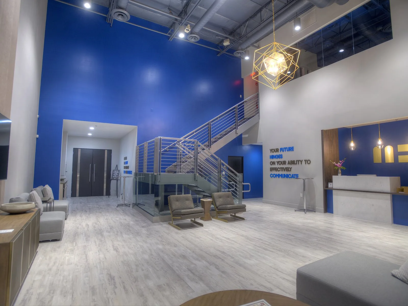 The two-story atrium with open staircase and effectively-communicate wall lettering