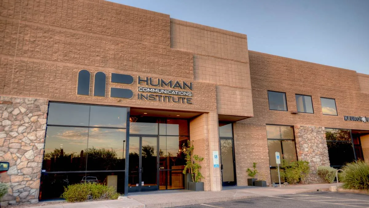 The Human Communications Institute building exterior at sunset
