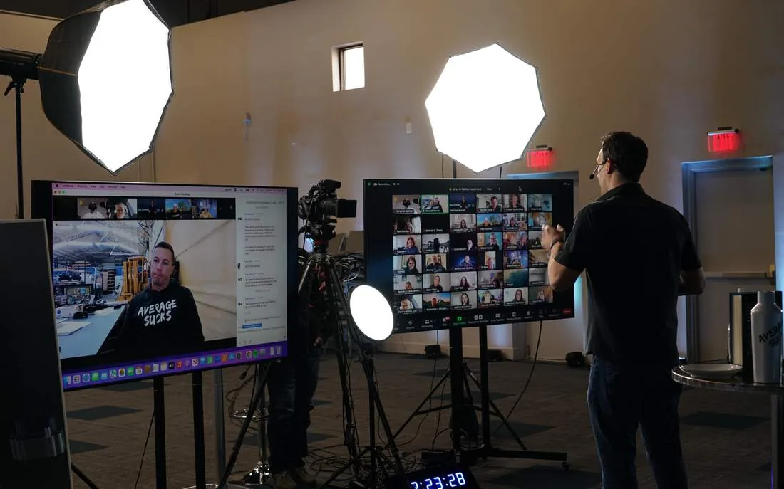 Broadcast cameras, softboxes, and confidence monitors set up for a virtual event